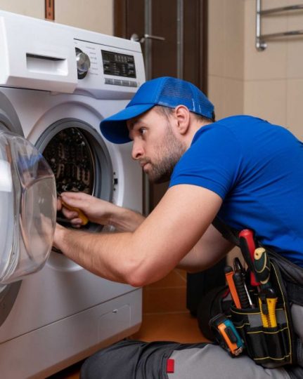 a technician repairing a washer and dryer repair athens